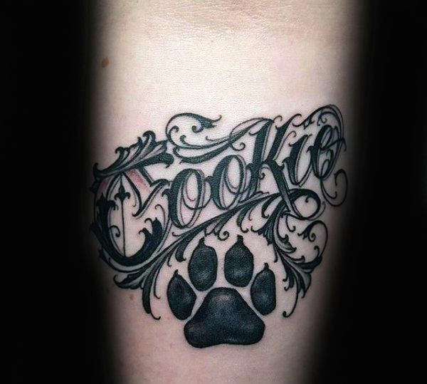 gentleman with memorial dog paw print lettering tattoo