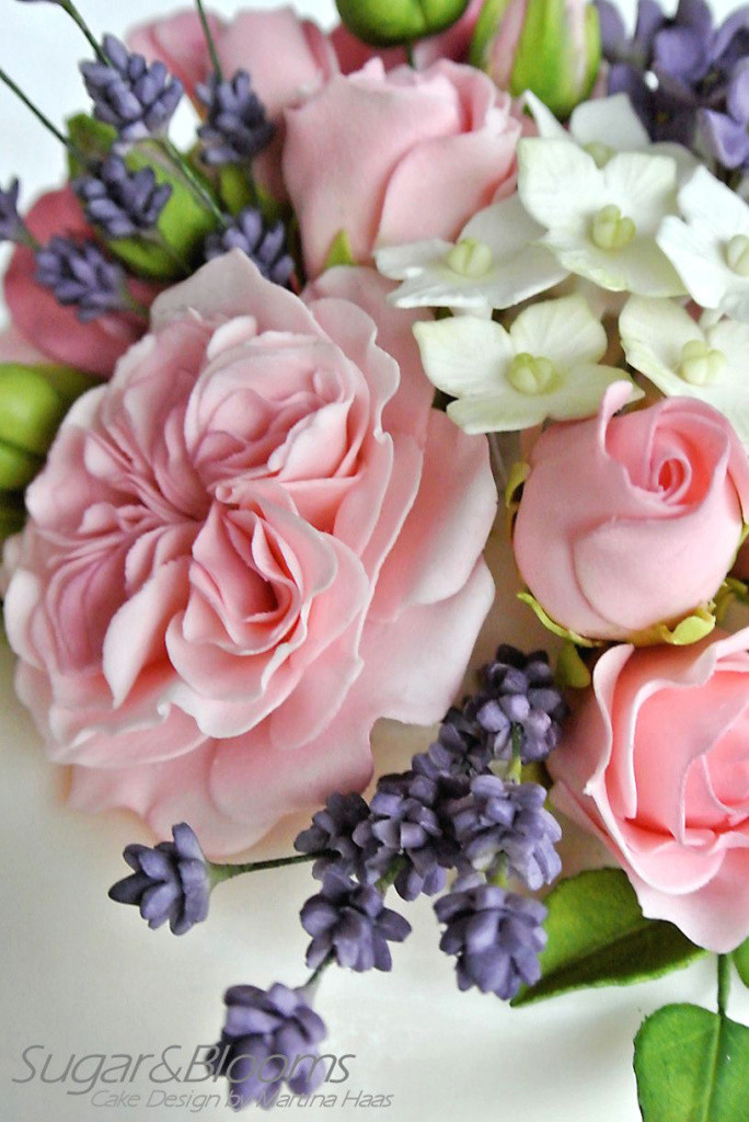 awesome mini wedding cake with sugar flowers in pink and lavender tones of fresh drawn vase