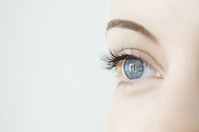 studio close up of mid adult womans gazing blue eye