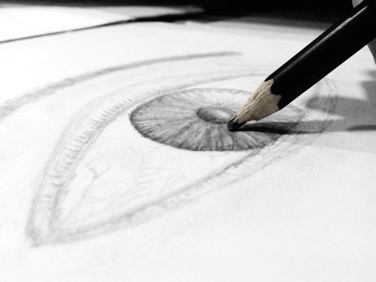 close up of human eye drawing on paper