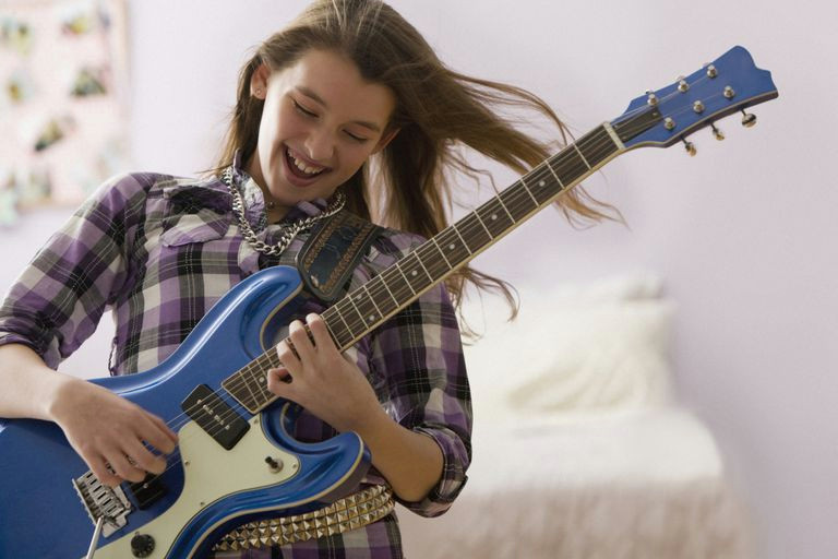 girl playing electric guitar