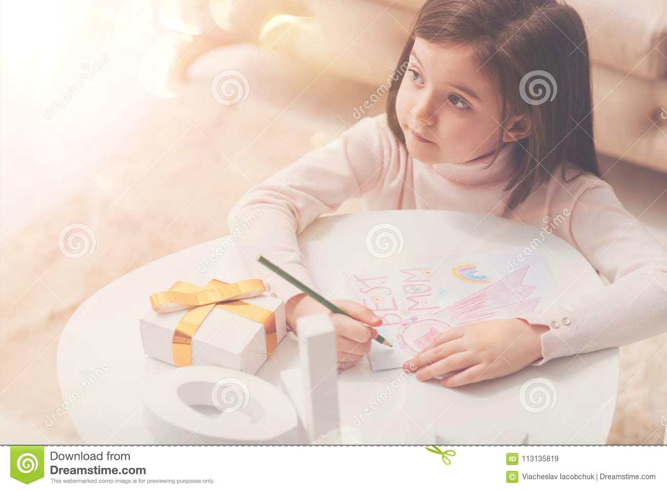 caring artistic girl making a picture for her mom
