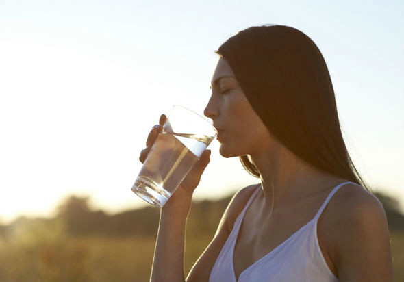 woman sipping glass of water