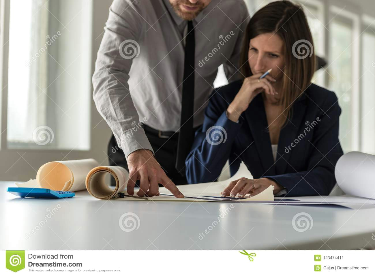 two architects discussing a drawing or blueprint