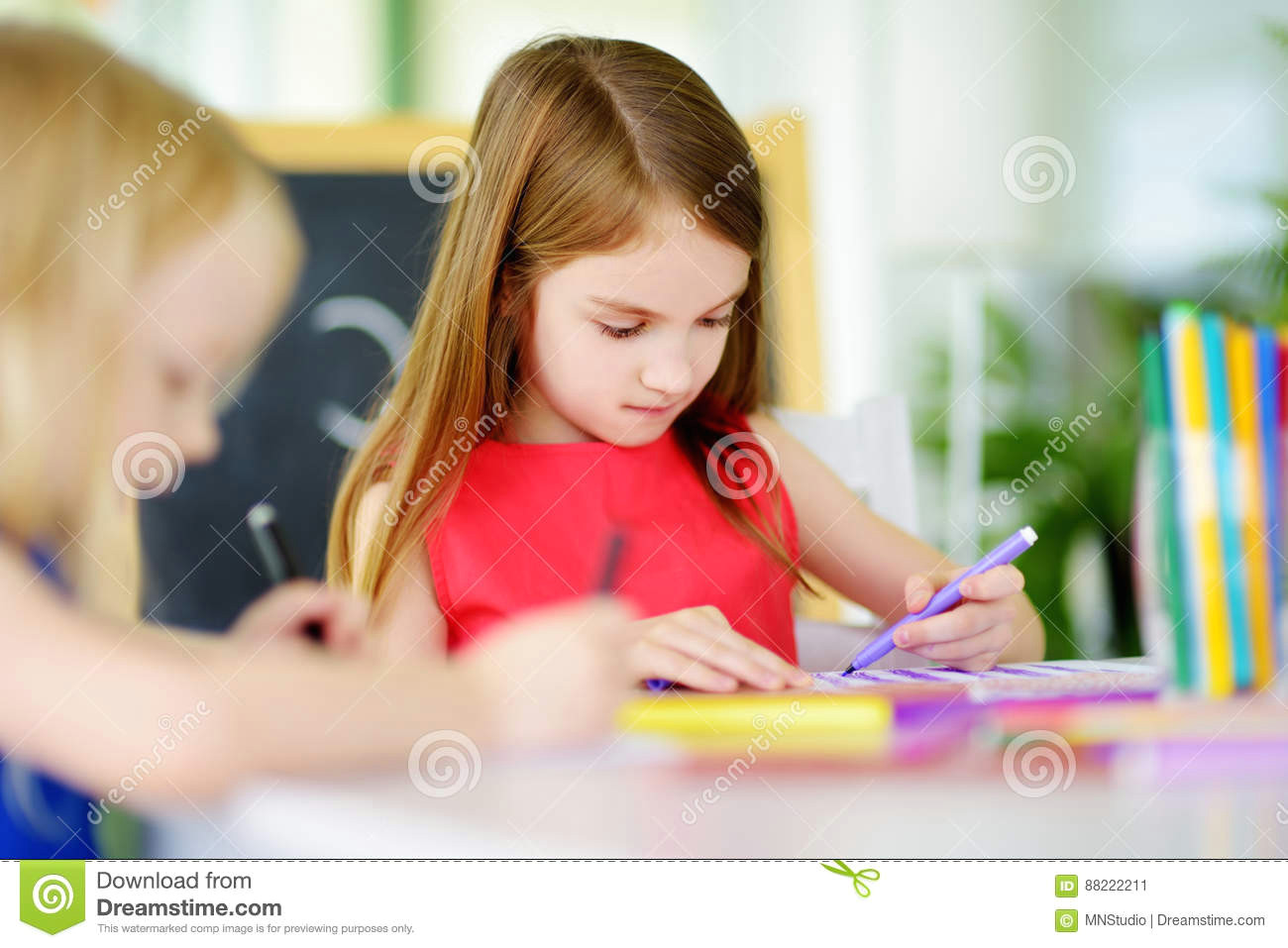 two cute little sisters drawing with colorful pencils at a daycare creative kids painting together girls doing homework at home
