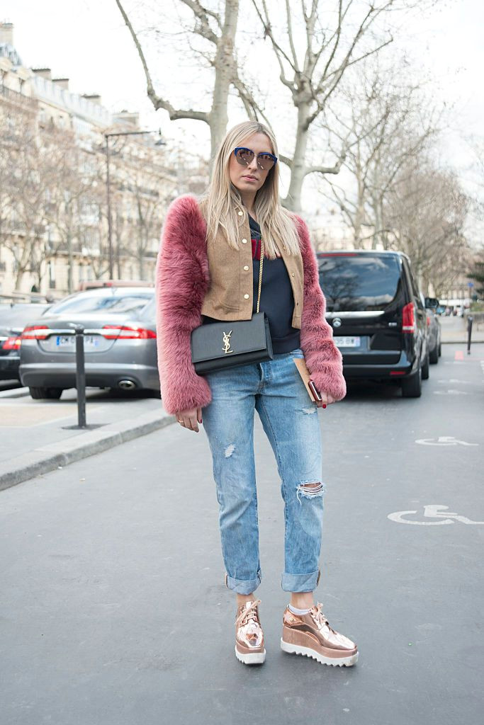street style photo of woman in jeans and faux fur