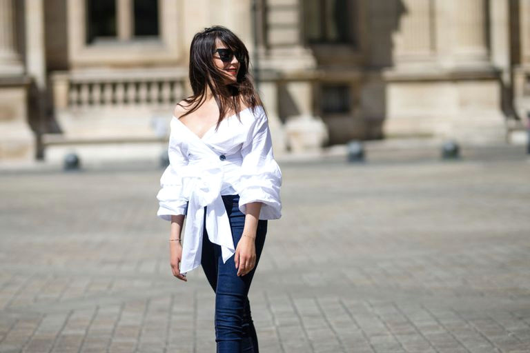 french street style woman s fashion outfit in jeans and an off the shoulder top