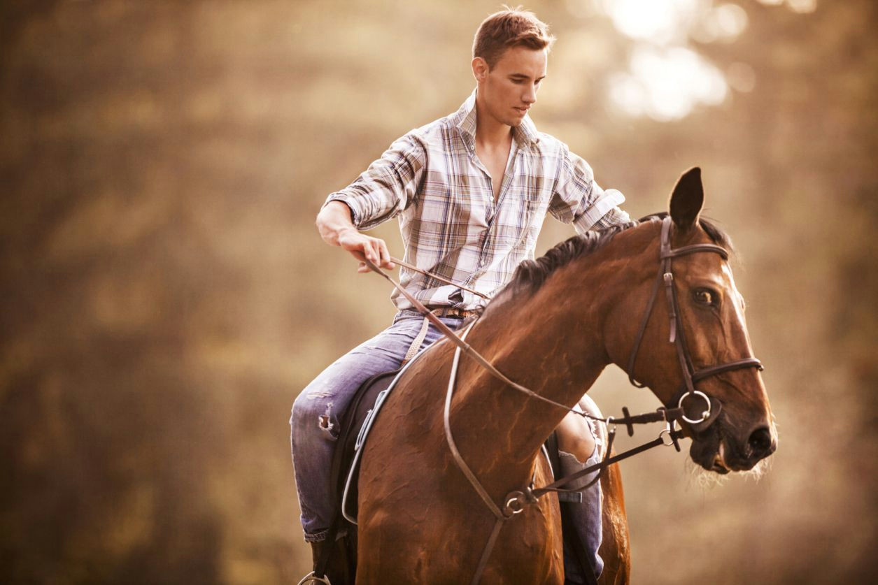 man struggling to control horse