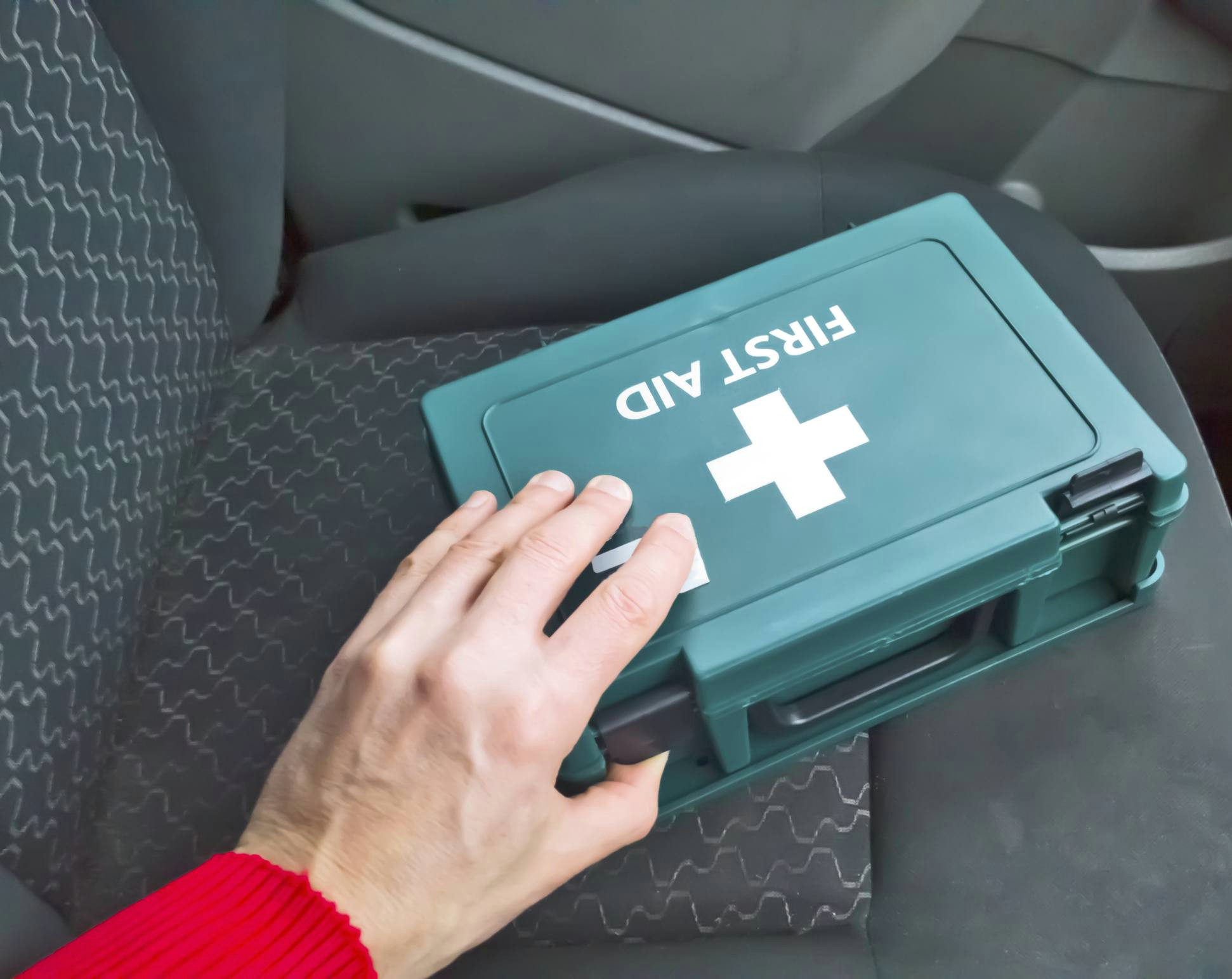 first aid box sitting on the seat of a car