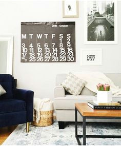 love this neutral family room setup the navy velvet chair and the gallery wall are
