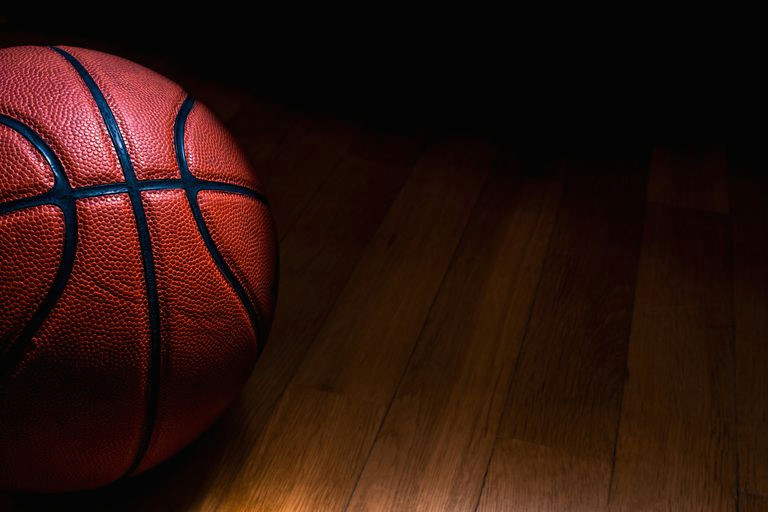 close up of basketball on hardwood floor