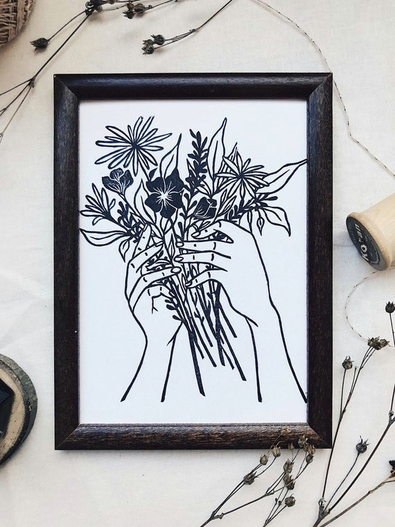 tattoo style hand holding flowers linocut block print art print minimalist floral hand carved stamp
