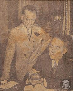 president manuel l quezon shown with speaker william bankhead of the us congress who is autographing a gavel for the president