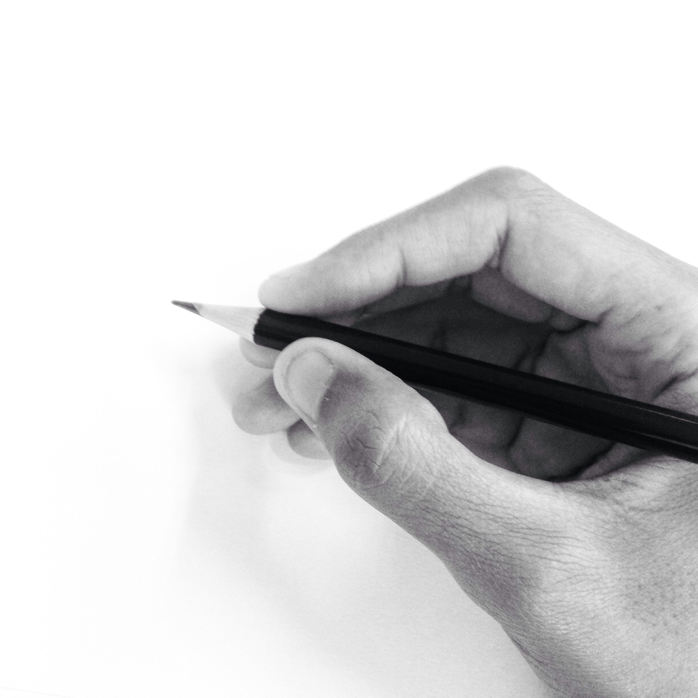 cropped hand of person holding pencil by white wall 681952377 59f0f299d088c00010f85526 jpg