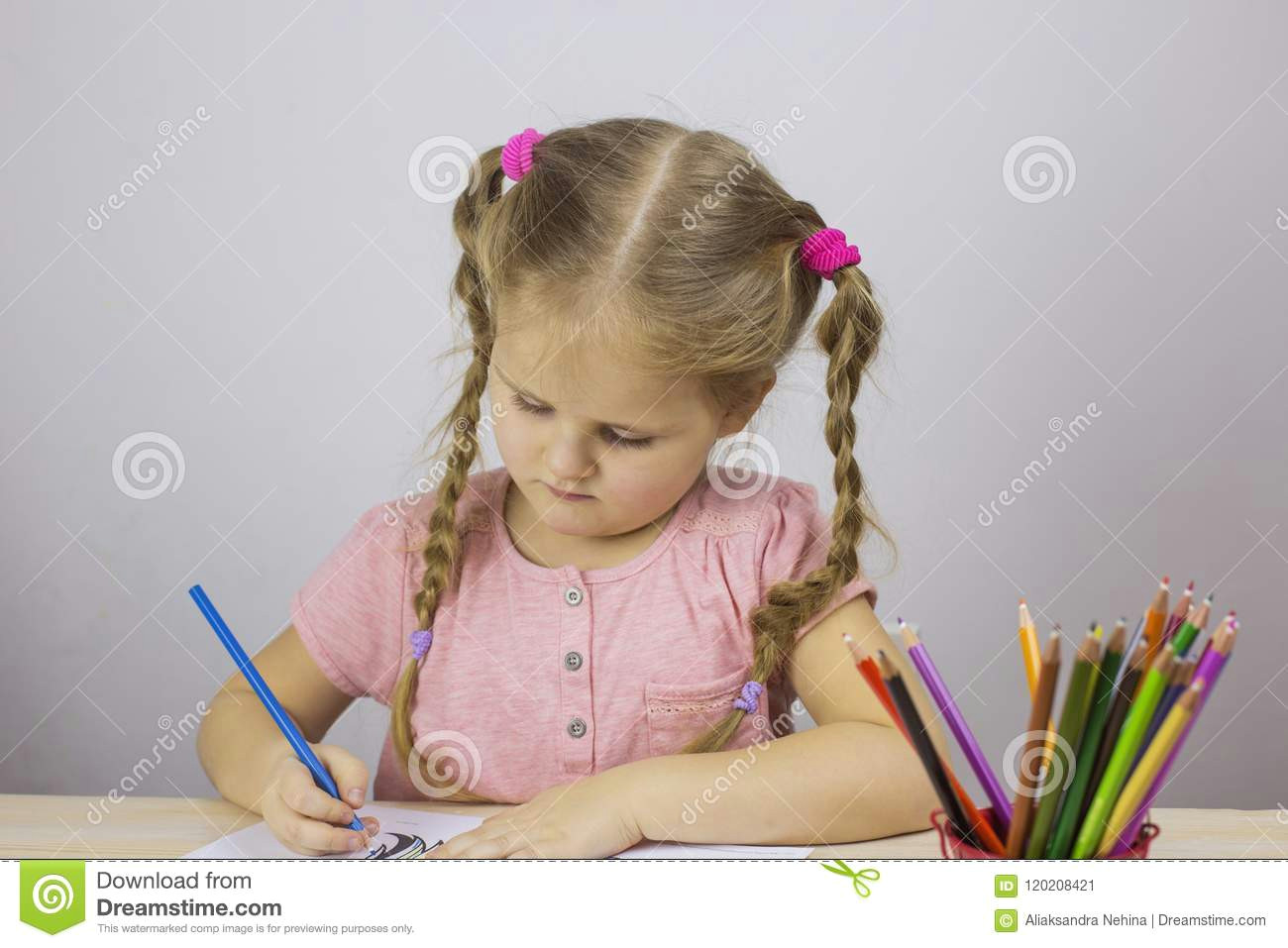 young girl draws colored pencils education concept young girl draws colored pencils table 120208421 jpg